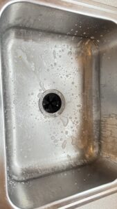 before and after stainless steel sink cleaning in a residential kitchen in Whitman MA