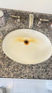 Sink before deep cleaning – limescale and stains present