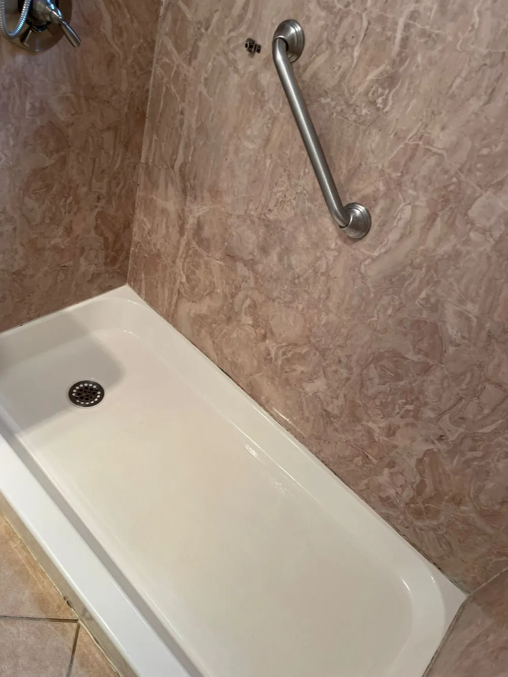 Shower pan cleaned to a bright white finish by Sirley Cleaning Services